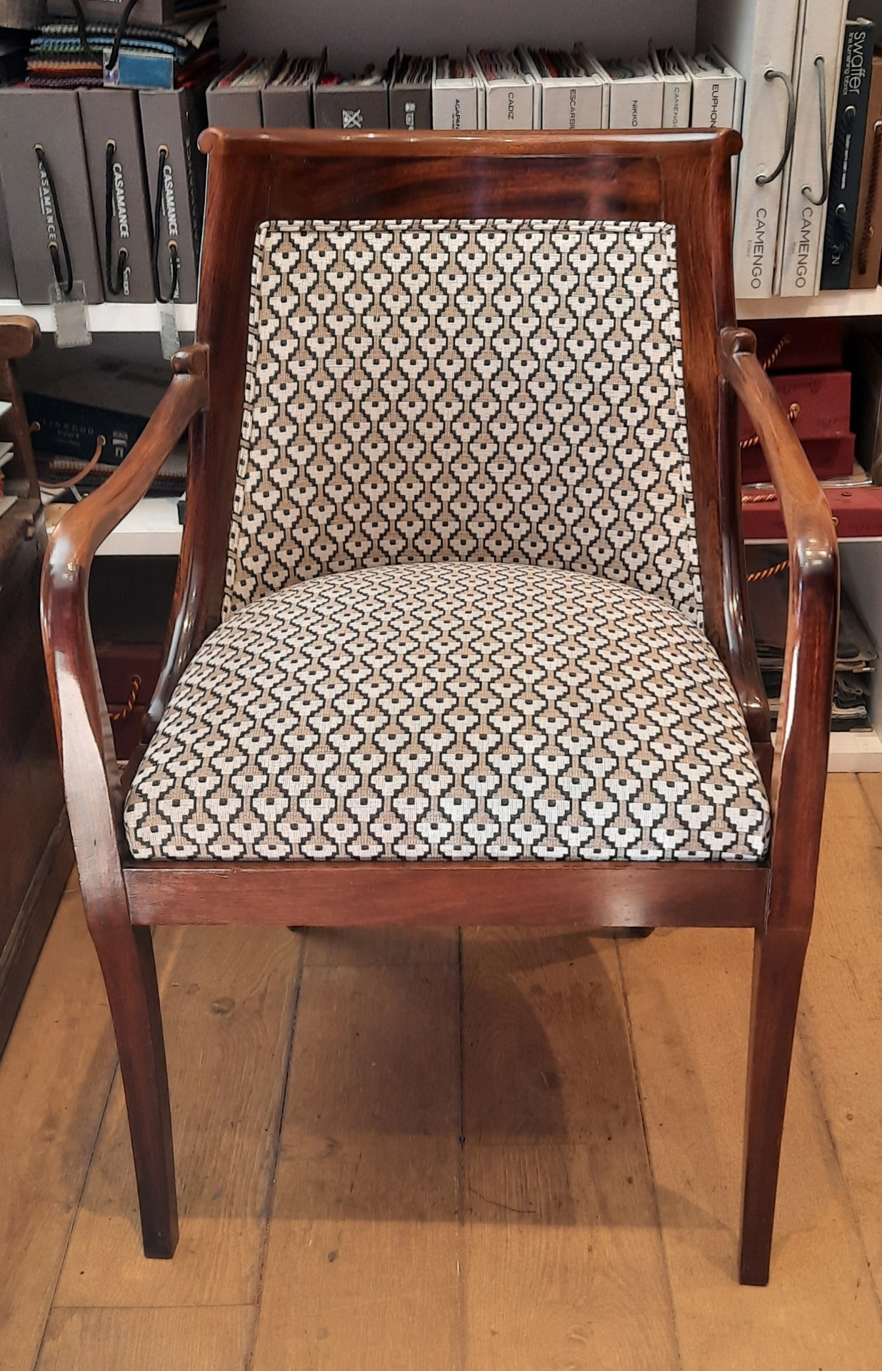 Fauteuil acajou garni en tissu à motifs géométriques beige et noir